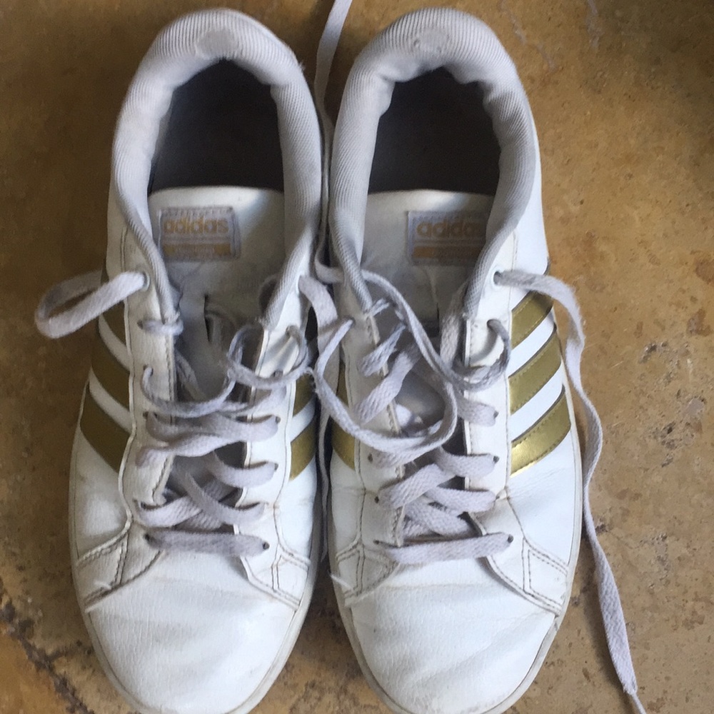 White with gold stripes adidas cloud foam shoes